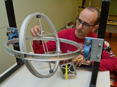 Un doctorand del NanoSat Lab preparant el giroscopi per fer càlculs de la rotació d'un CubeSat
