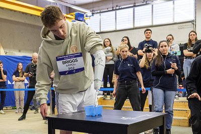 The carrier of the ARM2U team, Kyle Briggs, competing with the prosthesis at a Cybathlon 2023 event