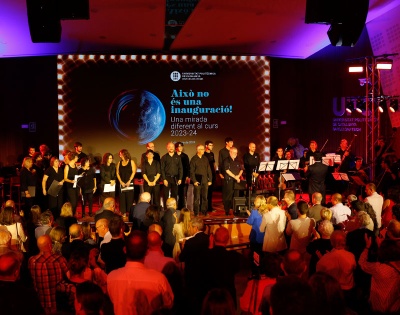 Interpretación del Gaudeamus igitur por parte de las corales de Arquitectura y de Terrassa, la Orquesta UPC y el grupo musical Cadencia industrial, junto con el público asistente en el acto